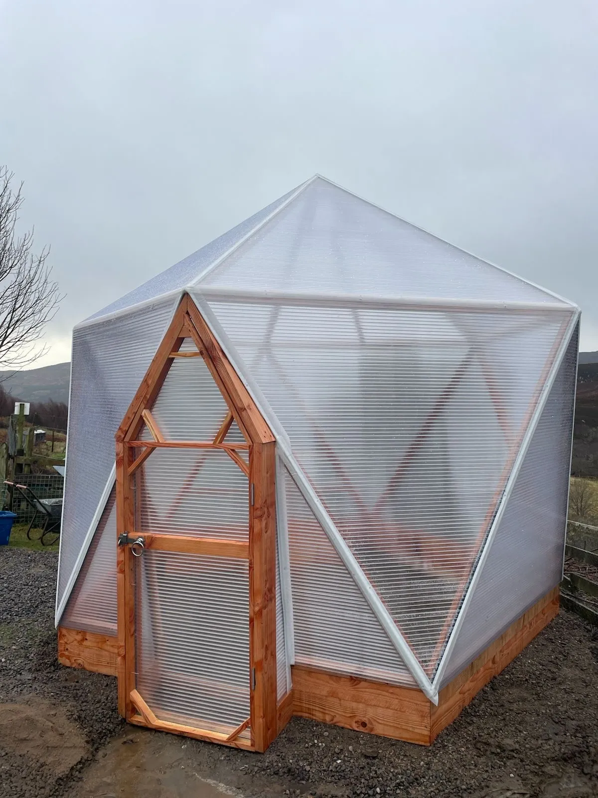 Geodesic dome architecture showing triple-wall polycarbonate cladding and UV-treated timber